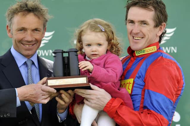 legendary rider John Francome (left) presents a jockeys' championship to the now retired Sir AP McCoy in 2010.