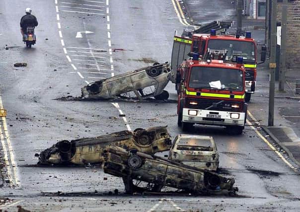 Burned out cars in the Manningham area of Bradford, after a night of violence in 2001.