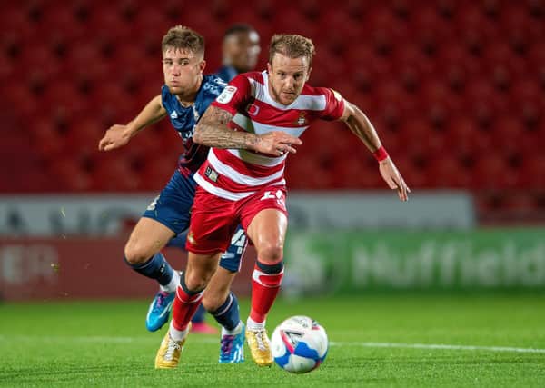 Doncaster Rovers' James Coppinger competes with Bradford City's Finn Cousin-Dawson.  Picture Bruce Rollinson