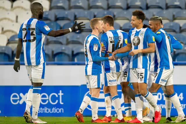 Own goal: Huddersfield celebrate Etienne Capoue's own goal.  Picture: Bruce Rollinson