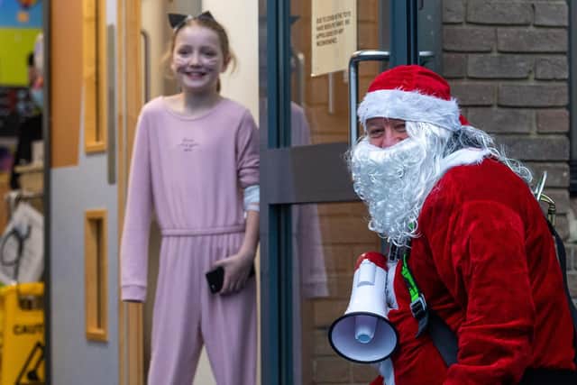 Santa chatting to patient Darcie Jones, eight, at Leeds Children's Hospital.

Photo: James Hardisty