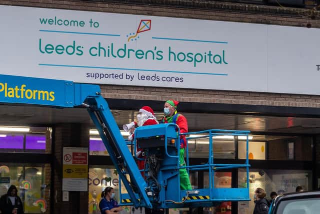 Santa and his Elf helper on a cherry picker at Leeds Children's Hospital.

Photo: James Hardisty