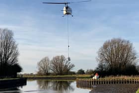 The helicopter lifting one-tonne bags to drop into the breach on the Aire and Calder
Picture: Stephen Hardy