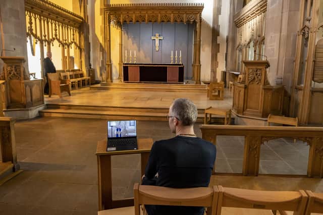A parishoner watches the Archbishop of Canterbury speak during an online service at the start of the Covid pandemic.