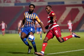 Doncaster Rovers' Fejiri Okenabirhie (right) and Shrewsbury Town's Ro-Shaun Williams battle for the ball. Pictures: PA.