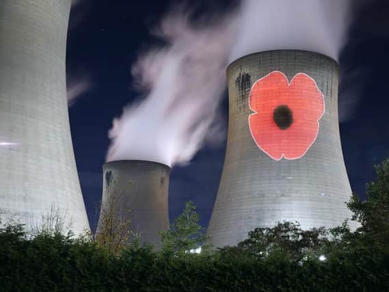 A poppy projected onto a cooling tower at Drax Power Station during  Remembrance Sunday