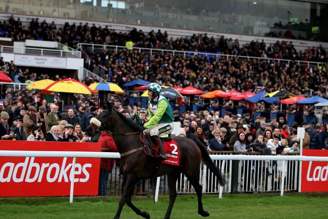 Sam Twiston-Davies parades Clan Des Obeaux i front of the packed Kempton stands after last year's King George.