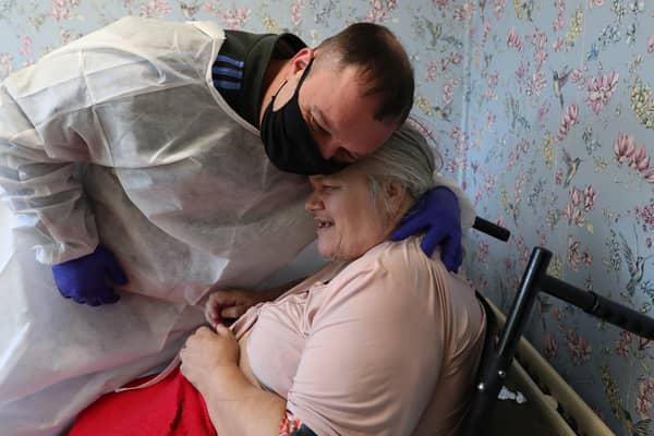Chris Mills embraces mum Carol Roberts during Christmas Day visit at Aspen Hill Village care home, Hunslet.