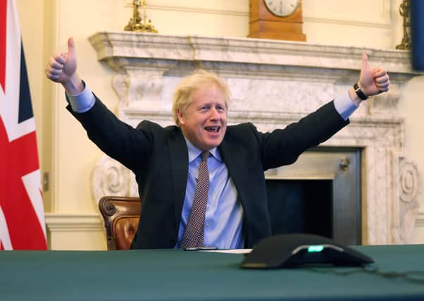 Boris Johnson celebrates after a trade deal with the EU is finally struck on Christmas Eve.