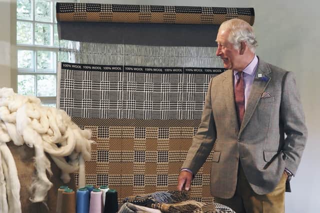 HRH The Prince of Wales steps out in tweed on a visit to Johnstons of Elgin which has collaborated with Amy Powney on a Campaign For Wool limited edition scarf range.