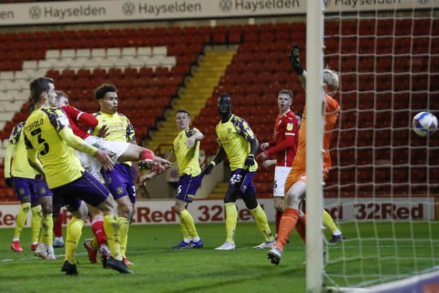 Barnsley's Malik Helik of Bscores his side's winning goal against Huddersfield Town during their derby showdown at Oakwell. Picture: Darren Staples/Sportimage