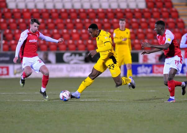 TIGHT TUSSLE: Barnsley's 
Victor Adeboyejo of Barnsley takes on Rotherham's Dan Barlaser. Picture: Steve Riding.