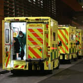 A paramedic opening the rear door of one of the ambulances queued outside the Royal London Hospital, in London. Photo: PA