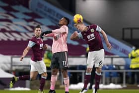 Burnley captain Ben Mee heads clear with Sheffield United rival Lys Mousset in close proximity. Picture: SPORTIMAGE.