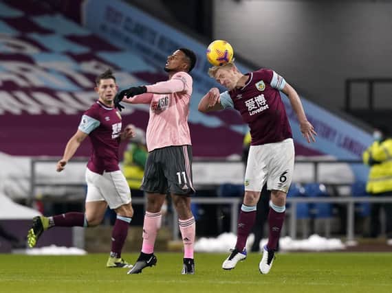 Burnley captain Ben Mee heads clear with Sheffield United rival Lys Mousset in close proximity. Picture: SPORTIMAGE.