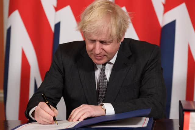 Prime Minister Boris Johnson signs the EU-UK Trade and Cooperation Agreement at 10 Downing Street, Westminster, paving the way for Brexit to finally happen this New Year. Photo: PA/Leon Neal