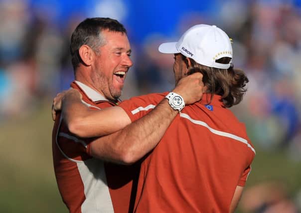 Team Europe's Tommy Fleetwood celebrates victory on the 14th with Team Europe vice captain Lee Westwood during the Foursomes match on day two of the Ryder Cup in September 2018. Picture: Gareth Fuller/PA.