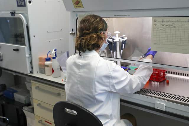 A scientist at work in a vaccine manufacturing laboratory. Picture: Steve Parsons / PA Wire