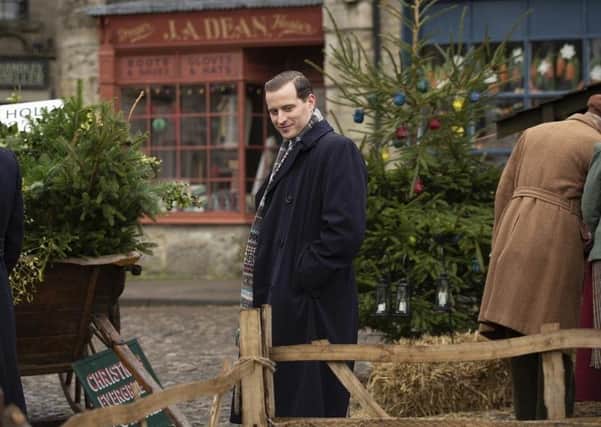 James Herriot (Nicholas Ralph) soaks up Darrowby square's festive atmosphere in All Creatures Great and Small. Picture: Channel 5