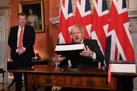 UK chief trade negotiator, David Frost looks on as Prime MinisterPrime Minister Boris Johnson signs the EU-UK Trade and Cooperation Agreement at 10 Downing Street, Westminster.