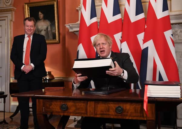 UK chief trade negotiator, David Frost looks on as Prime MinisterPrime Minister Boris Johnson signs the EU-UK Trade and Cooperation Agreement at 10 Downing Street, Westminster.