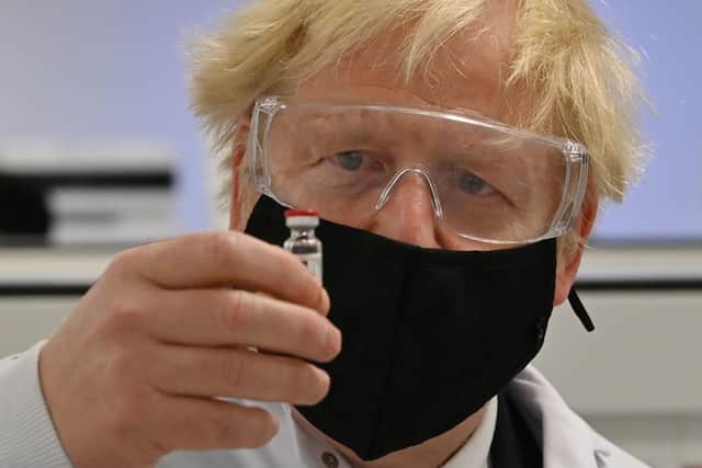 Prime Minister Boris Johnson holds a vial of the Oxford/AstraZeneca vaccine. Picture: Paul Ellis/PA Wire