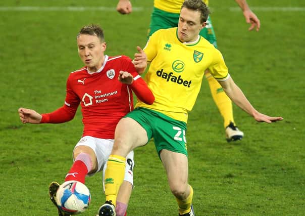 Challenge: Norwich City's Oliver Skipp and Barnsley's Cauley Woodrow battle for the ball.
