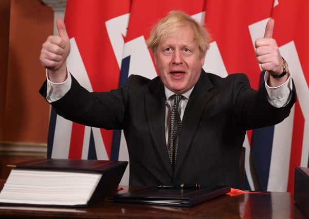 Boris Johnson gives a thumbs up after signing a Brexit trade deal with the European Union.