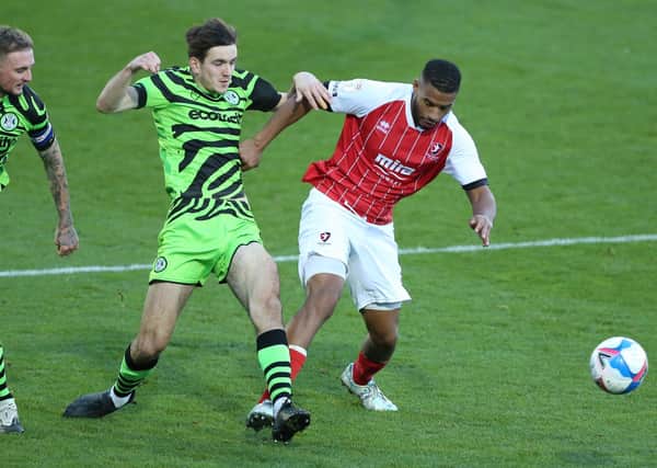 Cheltenham Town's Reuben Reid (right) and Forest Green Rover's Liam Kitching (centre) battle for the ball. Picture: PA