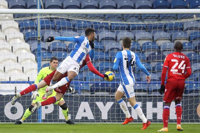 YOU'RE IN: Huddersfield Town's Fraizer Campbell scores his side's first goal against Reading at The John Smith's Stadium. Picture: Martin Rickett/PA