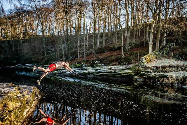 Les Peebles dives into the River Ribble near Stainforth in North Yorkshire. Mr Peebles is swimming in the wild every day in January to raise money for the homelessness charity Crisis. Photo credit: Danny Lawson/PA Wire