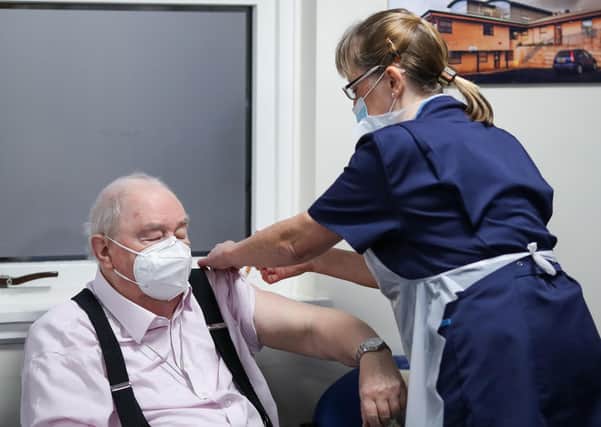 Ian Cormack receives the Oxford/AstraZeneca coronavirus vaccine, administered by Practice Nurse Ruth Davies, at Pentlands Medical Centre in Edinburgh. Picture: Russell Cheyne/PA Wire