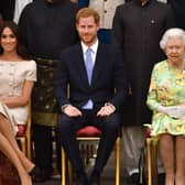Meghan, Duchess of Sussex, Prince Harry, Duke of Sussex and Queen Elizabeth II at the Queen's Young Leaders Awards Ceremony at Buckingham Palace on June 26, 2018. (Photo by John Stillwell - WPA Pool/Getty Images)