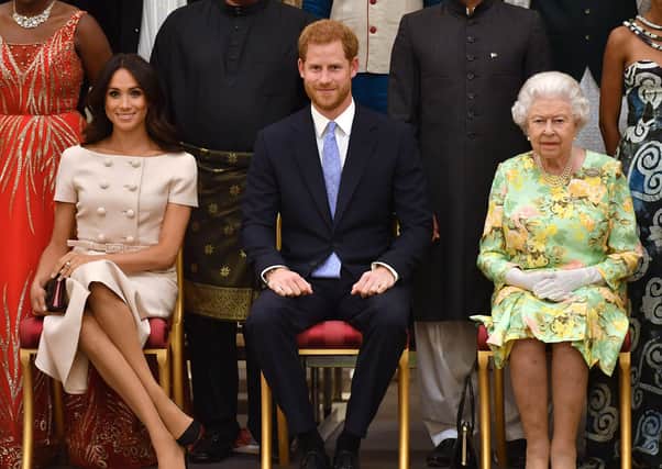 Meghan, Duchess of Sussex, Prince Harry, Duke of Sussex and Queen Elizabeth II at the Queen's Young Leaders Awards Ceremony at Buckingham Palace on June 26, 2018. (Photo by John Stillwell - WPA Pool/Getty Images)