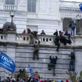 Supporters of President Donald Trump climb the west wall of the the U.S. Capitol to disrupt the confirmation of Joe Biden as the next President of the United States.