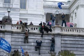Supporters of President Donald Trump climb the west wall of the the U.S. Capitol to disrupt the confirmation of Joe Biden as the next President of the United States.