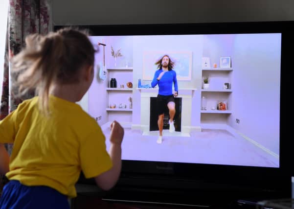 Four-year-old Lois Copley-Jones, who is the photographer's daughter, takes part in a live streamed broadcast of PE with fitness trainer Joe Wicks on the first day of the nationwide school closures on March 23, 2020 (Photo by Gareth Copley/Gareth Copley)