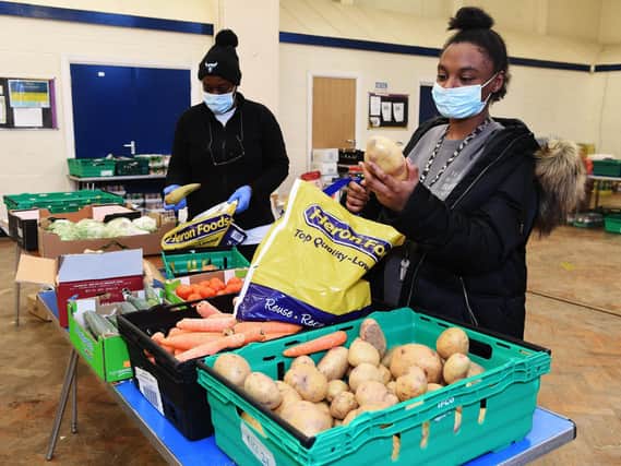 Touchstone Loves Food volunteers Erica Martin and Tanika Lewis packing food bags at Ebor Gardens Community Centre in Leeds.
