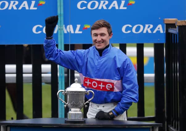 A battered and bruised Adam Wedge celebrates Secret Reprieve's Coral Welsh Grand National win.