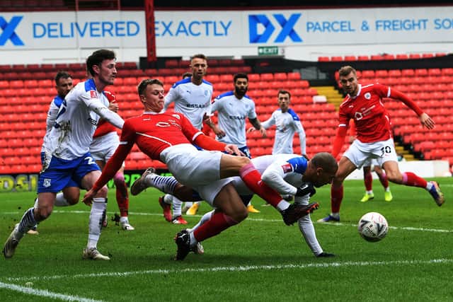 Barnsley's Mads Anderson battles with Tranmere's James Vaughn.
 (Picture: Jonathan Gawthorpe)