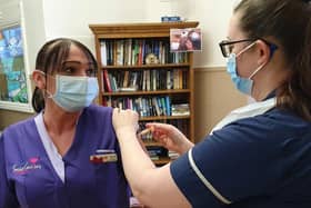 Pictured, Karen Howden, Housekeeper at Saint Cecilia’s Care Home, receiving her Pfizer/BioNTech vaccination. Photo credit: submitted picture.