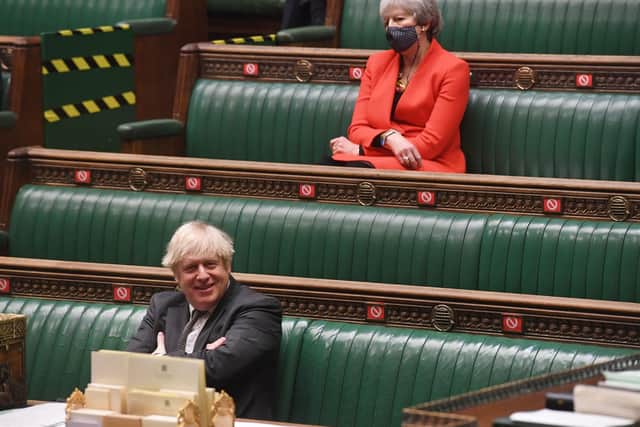 Theresa May in the House of Commons, sitting 9socially distanced) from her successor Boris Johnson.