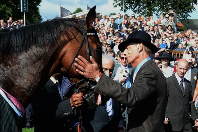 Prince Khalid Abdullah is just visible as Sir Henry Cecil strokes Frankel after the superstar horse won the 2012 Juddmonte International at York.