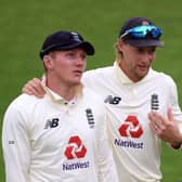 Spin threat: England's Joe Root with Dom Bess.