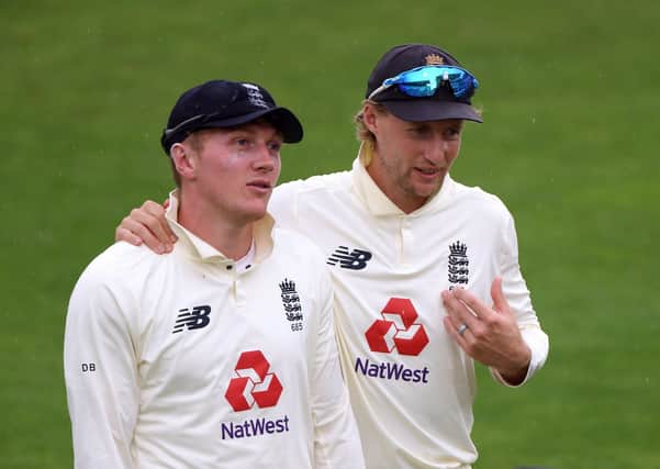 Spin threat: England's Joe Root with Dom Bess.