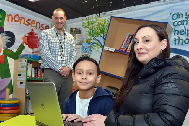 David Richards has helped pioneer the Laptops For Kids scheme in Sheffield that ensures pupils such as Castro Hart-Richards, pictured with his mother Vikki Hart and Athelstan Primary School assistant headteacher James Mills.
