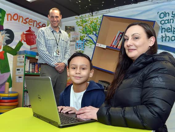 David Richards has helped pioneer the Laptops For Kids scheme in Sheffield that ensures pupils such as Castro Hart-Richards, pictured with his mother Vikki Hart and Athelstan Primary School assistant headteacher James Mills.