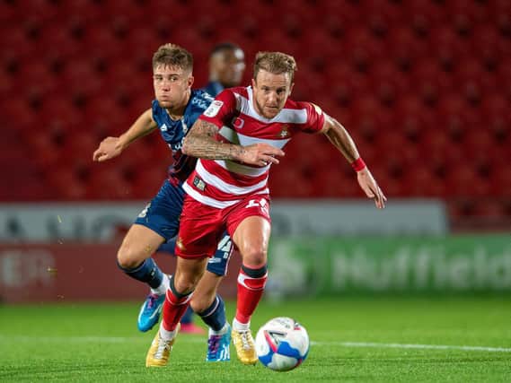REGULAR: Finn Cousin-Dawson, pictured with Doncaster Rovers' James Coppinger, has played every minute under interim managers Mark Trueman and Conor Sellars