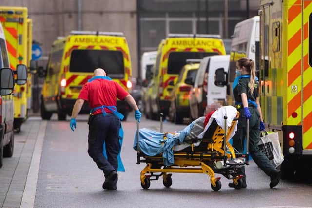 Paramedics unload a patient from an ambulance outside the Royal London Hospital in London. Photo: PA