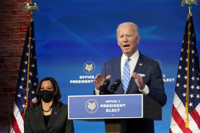 President-elect Joe Biden speaks about the COVID-19 pandemic during an event at The Queen Theater, Thursday, Jan. 14, 2021, in Wilmington, Del., as Vice President-elect Kamala Harris listens. (AP Photo/Matt Slocum)